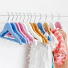 Boutique Wooden Kids Clothing Hanger displaying colorful hangers with children's clothing.