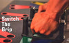 Close-up of a hand switching grip on a Complete Push Up Training System for enhanced workout effectiveness.