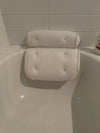 Non Slip Take Bath Pillow with Suction Cups resting on the edge of a bathtub.