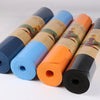Thick Solid Yoga Mat for Fitness in blue, orange, and black colors neatly rolled up for exercise and yoga.