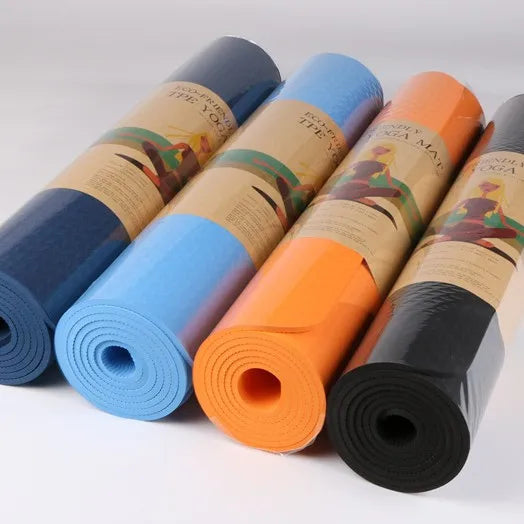 Thick Solid Yoga Mat for Fitness in blue, orange, and black colors neatly rolled up for exercise and yoga.