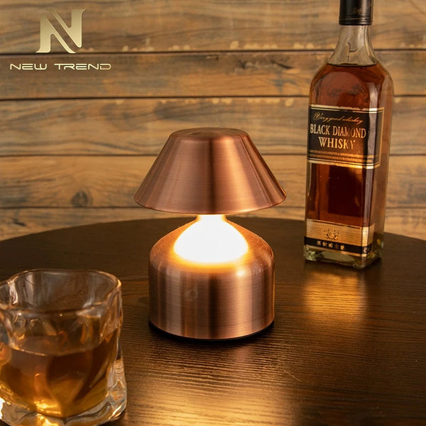 Retro Acrylic LED Desk Lamp Glow illuminating a cozy setting with whiskey and glass on a table.