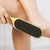 Person using the Foot Rub Exfoliating Scrub Grinding Stone on their foot to remove rough patches.