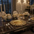 European Style Irregular Hollow Plating Plate on a beautifully set dining table with floral centerpieces and elegant candle holders.