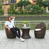 Woman relaxing in a Garden Lounge Wicker Furniture Set by a riverside.