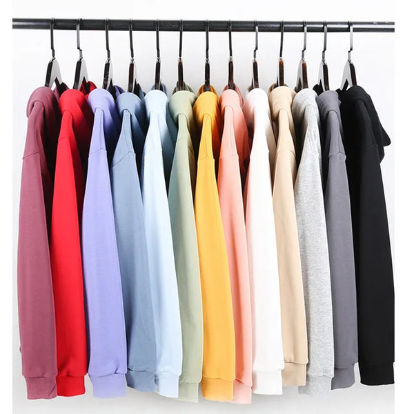 Unisex Oversized Blank Hoodies in various colors hanging on a rack.