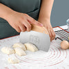 Stainless Steel Flour Sifter Baking Tool used for measuring and cutting dough on a baking mat.