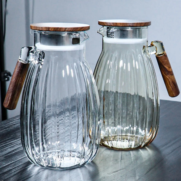 High-Temperature Resistant Dining Table Placemat: Clear and amber glass pitchers with wooden lids and handles, stylish kitchenware for serving beverages.