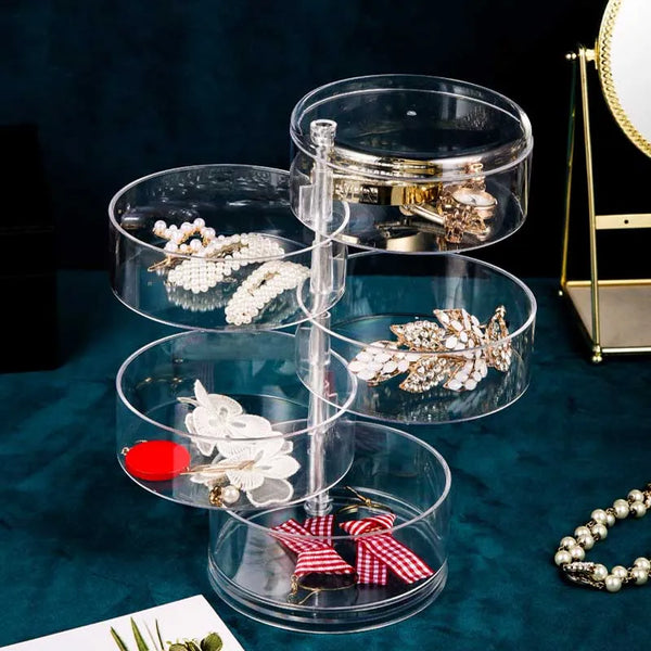 Clear 360 Rotatable Jewelry Box displaying various jewelry items in a transparent design.