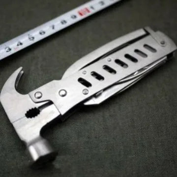 Outdoor Multi-Function Mini Claw Hammer shown with a ruler for size comparison on a dark surface.