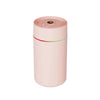 The Mini 420ml USB Air Humidifier in a pink color with a sleek design and top mist output.
