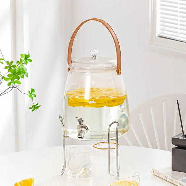 Glass Beverage Dispenser with Faucet showcasing lemon slices, stylish and functional for serving cold drinks.