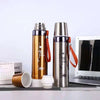 600ml Stainless Steel Thermos Bottle in gold and silver color next to a laptop and calendar.