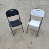 Foldable Plastic Outdoor Chair with Metal Frame in black and white colors on a concrete floor.