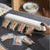 Portable Mini Food Vacuum Packing Organising Sealer in use with vacuum-sealed snack bars on a kitchen counter.