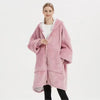 Model wearing an Oversized Sherpa Wearable Hoodie Blanket in pink, showcasing its cozy and plush design.