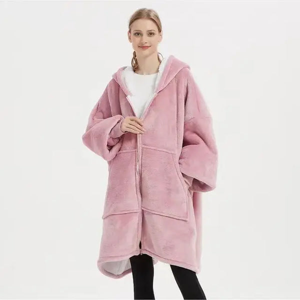 Model wearing an Oversized Sherpa Wearable Hoodie Blanket in pink, showcasing its cozy and plush design.