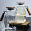 High-Temperature Resistant Dining Table Placemat: Elegant glass pitchers with wooden handles, perfect for serving beverages with style.