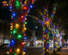 5m 240 LED Colourful Waterproof String Light illuminating trees in a vibrant, festive nighttime setting.