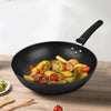 32cm Non-Stick Carbon Steel Iron Wok filled with colorful stir-fried vegetables and meats on a wooden table.