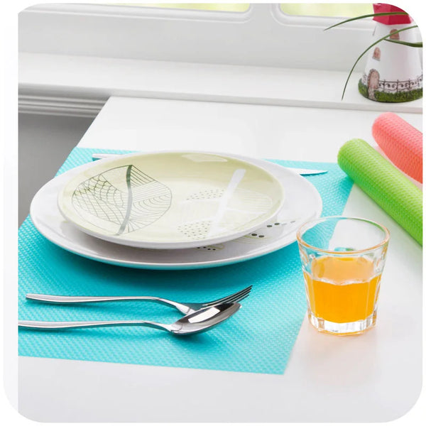 Multi-Purpose Anti-Slip Shelf & Fridge Mat 6-Pack used under plates and drinks on a stylish dining table.