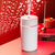 The Mini 420ml USB Air Humidifier emitting mist against a decorated red background, perfect for improving air quality.