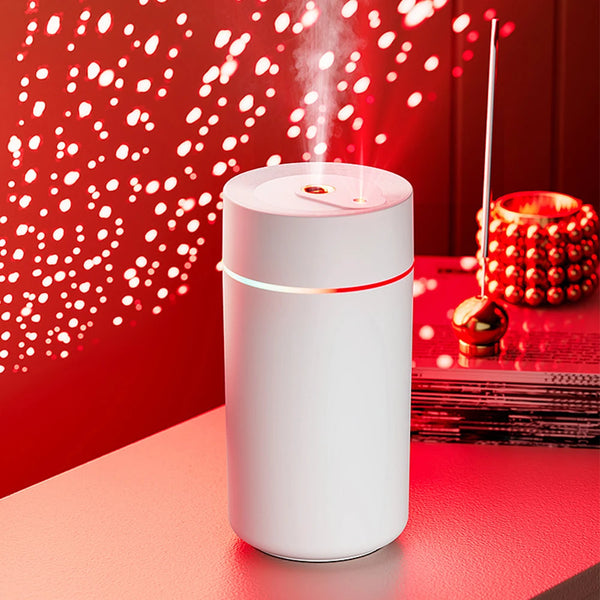 The Mini 420ml USB Air Humidifier emitting mist against a decorated red background, perfect for improving air quality.