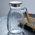 High-Temperature Resistant Dining Table Placemat displayed with a clear glass pitcher featuring a wooden lid and handle.