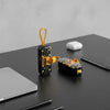 Transparent Capsule 5000mAh Mini Power Bank on a desk with smartphone and airpods, showcasing its portable charging design.
