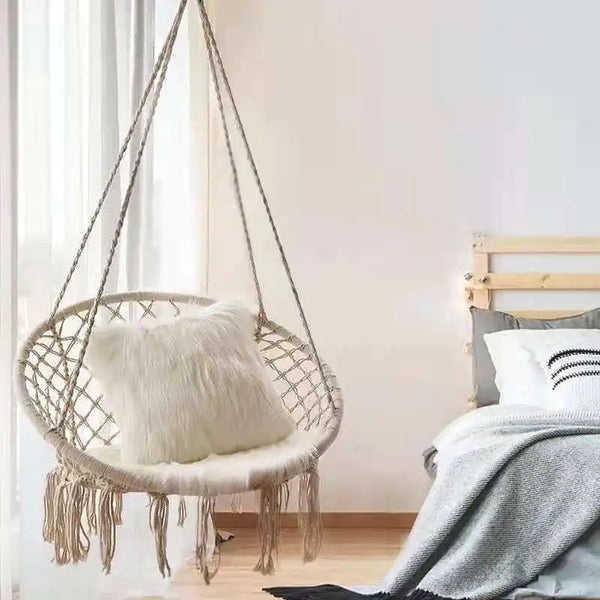 Portable Heavy Duty Outdoor Rope Hammock hanging in a cozy bedroom with a plush pillow and soft decor.