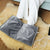 USB Graphene Constant Temperature Foot Warmer placed on a soft surface, providing warmth and comfort.