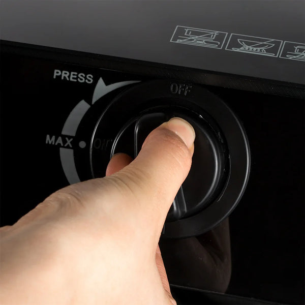 Hand adjusting the control knob on a Home Cooking Gas Stove, showcasing the off and max settings.