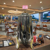 Stainless Steel Juicer Coffee Maker in a restaurant setting with modern decor and dining area.