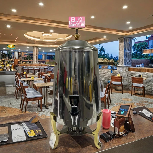Stainless Steel Juicer Coffee Maker in a restaurant setting with modern decor and dining area.