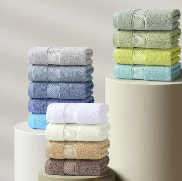 Thick Cotton Face and Hand Towel stacked in various colors on display, showcasing their plush and absorbent qualities.