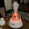 USB Mini Volcano Humidifier emitting mist with a warm red glow, enhancing air quality and ambiance in any space.