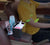 Car Armrest Cup Holder Storage Box with drinks and small items in a car interior for easy access.
