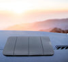 Anti-Slip Mobile Phone Stand and Holder on a dashboard during sunset.
