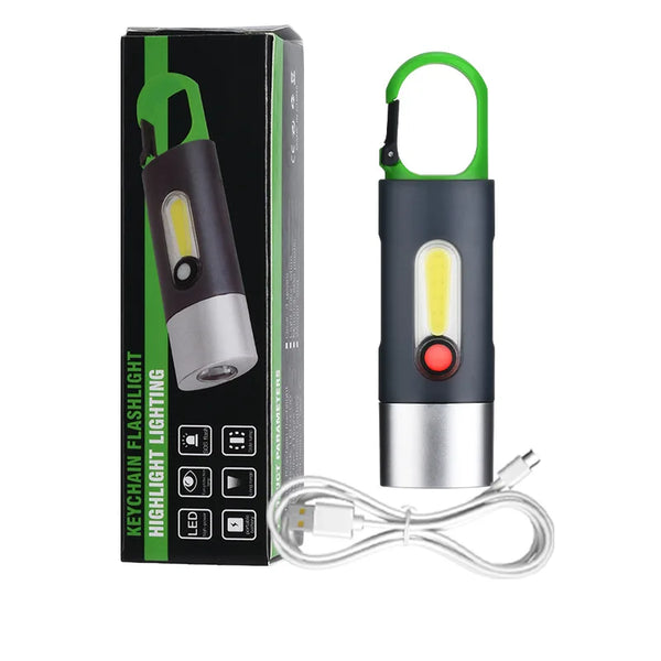 Portable Waterproof COB LED Rechargeable Keychain Light next to its packaging and charging cable.