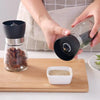 Manual Stainless Steel Pepper & Salt Grinder Mill in use, grinding pepper over a dish.