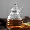 Hand-Blown Bee-Shaped Borosilicate Glass Honey Jar displaying honey, perfect for kitchen use, and showcasing unique design.