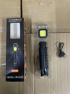 Portable COB LED Keychain Work Light with packaging and tripod on cardboard background.