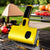 Heat-Resistant Electric Grill Brush Barbecue Cleaning Brush on grill with vegetables and cooked meat.