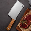 Heavy Duty Stainless Steel Bone Chopping Butcher Cleaver on a cutting board with raw meat and herbs.
