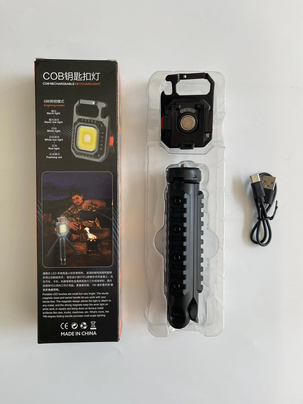 Portable COB LED Keychain Work Light with tripod, packaging and USB cable, ideal for hands-free illumination.