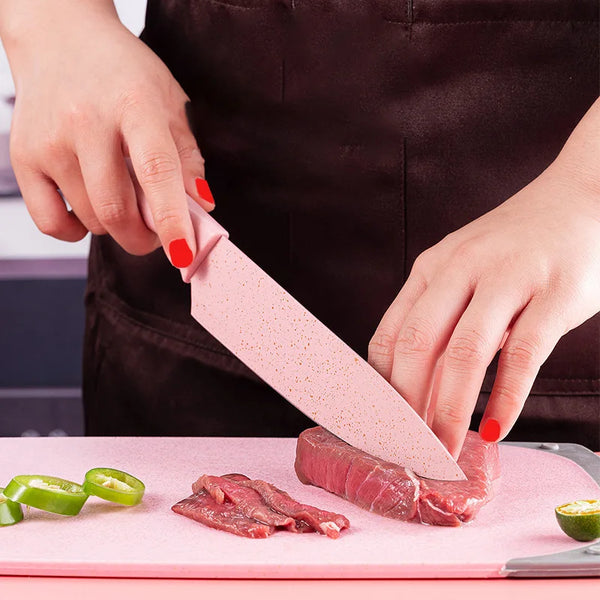 Person using a pink non-stick knife from the Non-Stick Stainless Steel 6 Piece Knife Collection to slice beef.