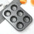 Non-Stick Carbon Steel Bakeware Set featuring a 6-cup muffin pan with flower-shaped molds.