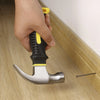 8oz Stubby Claw Hammer with Magnetic Nail Starter being used to drive a nail into wooden flooring.