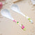 Two Ceramic Flower Handle Soup Spoons stylishly displayed on a light surface, showcasing elegant floral designs.