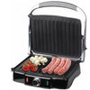 4-Slice Sandwich Press and Electric Contact Grill cooking sausages and vegetables on grill plates.